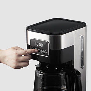 Digital screen on a black and silver coffee machine.