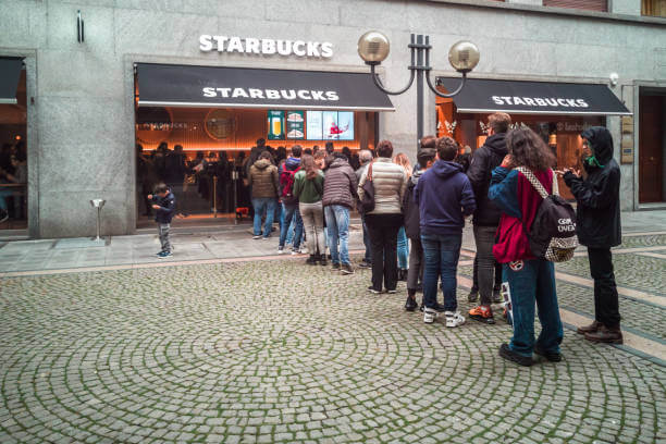 Queue of people entering in the newly open Starbucks Coffee in Turin. 