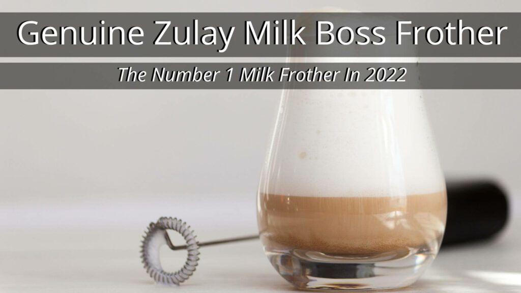 Genuine Zulay Milk Boss Frother next to a frothy glass of coffee