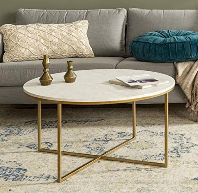 Round white marble coffee table with gold crisscross legs