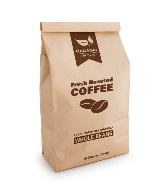A brown paper bag full of organic fair trade coffee beans fresh roasted