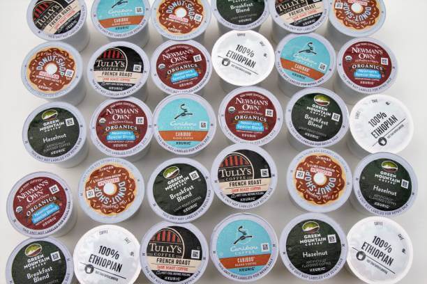 A large group of various brands of coffee pods for Keurig single cup coffee makers. Brands include Donut Shop, Tully's, Coffee Cafe, Green Mountain, Newman's Own, and Caribou. There are various blends of coffee, an Ethiopian coffee, French roast and hazelnut.
