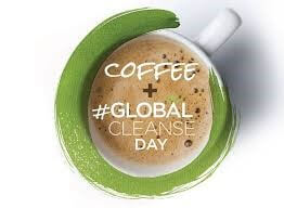 A white cup with a green rim Advertising the slogan global cleanse day