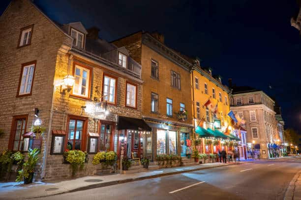 People walk along the historic restaurants and shops in downtown Quebec city Canada