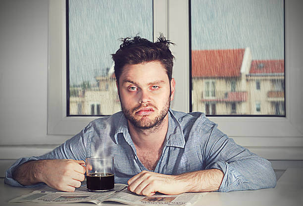 Monday morning again - A grumpy looking man with a cup of coffee
