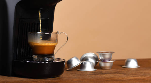 Espresso machine making coffee in glass cup
