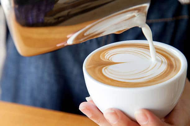 Pouring latte art into the cup
