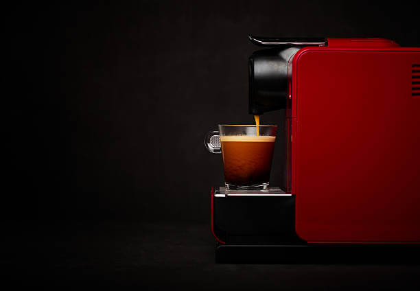 Coffee machine with cup of coffee with a dark background