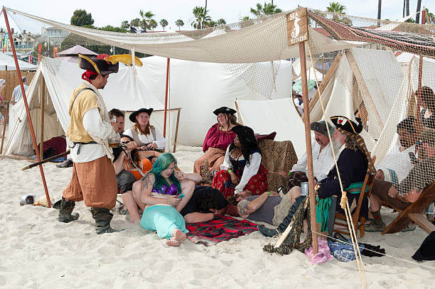 The Pirate Invasion, a pirate and mermaid themed festival was held at the Belmont Veterans Memorial Pier. A group of pirates and wenches rest in their camp on the beach.