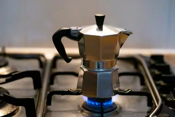 Moka coffee maker preparing an espresso on the natural gas stove
