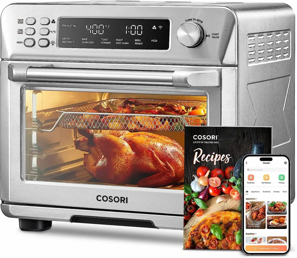 A silver toaster oven with a golden roasted chicken baking inside.