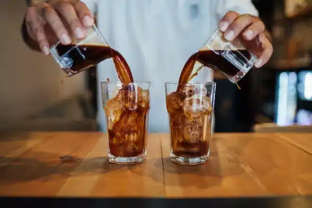 Cold brew coffee poured into two glasses with ice.