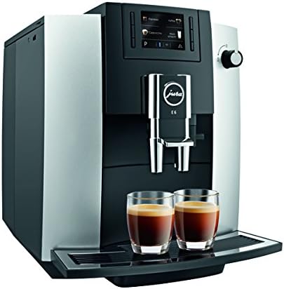 Large silver and black coffee espresso machine with two glass cups filled with black coffee sitting under the coffee dispenser.