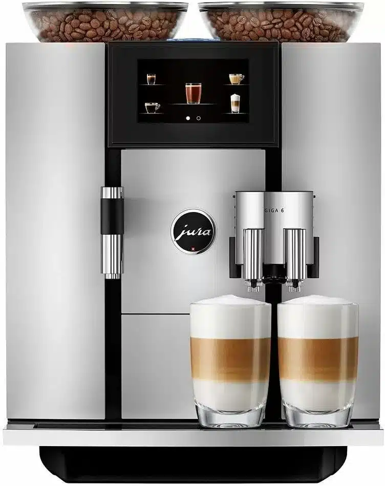 Black and silver coffee machine with full coffee bean holders and 2 glasses of creamy white coffee.